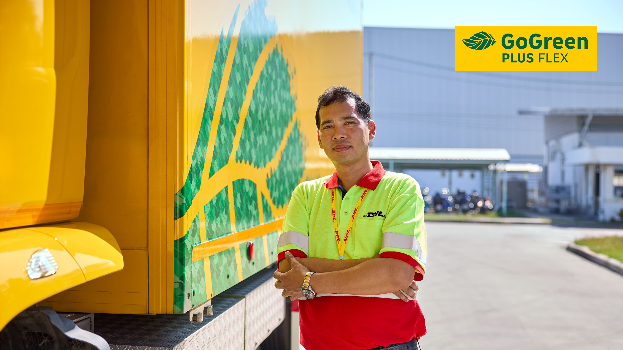 DHL driver next to a DHL GoGreen truck