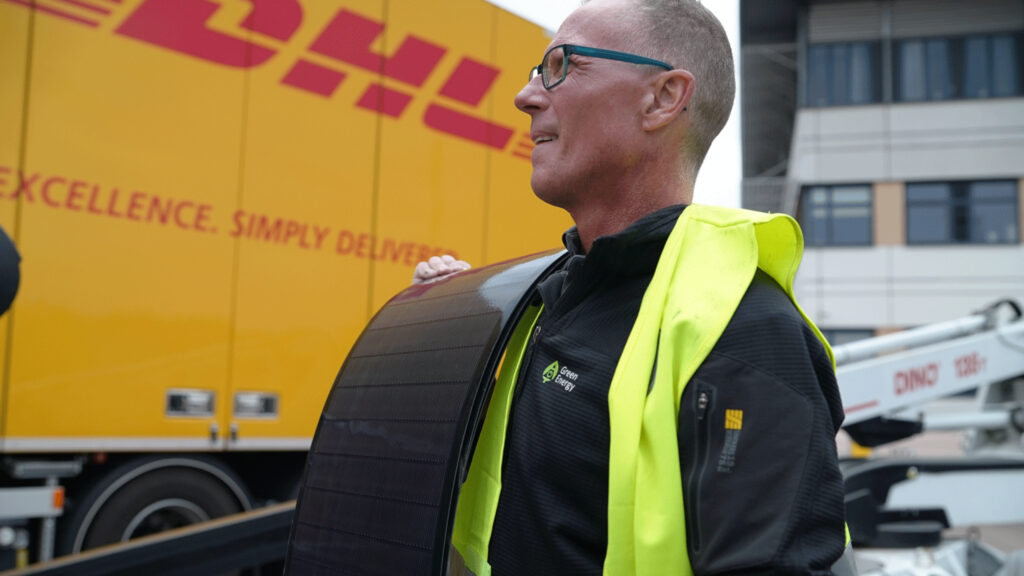 Employee of Green Energy Group with CIGS solar panels